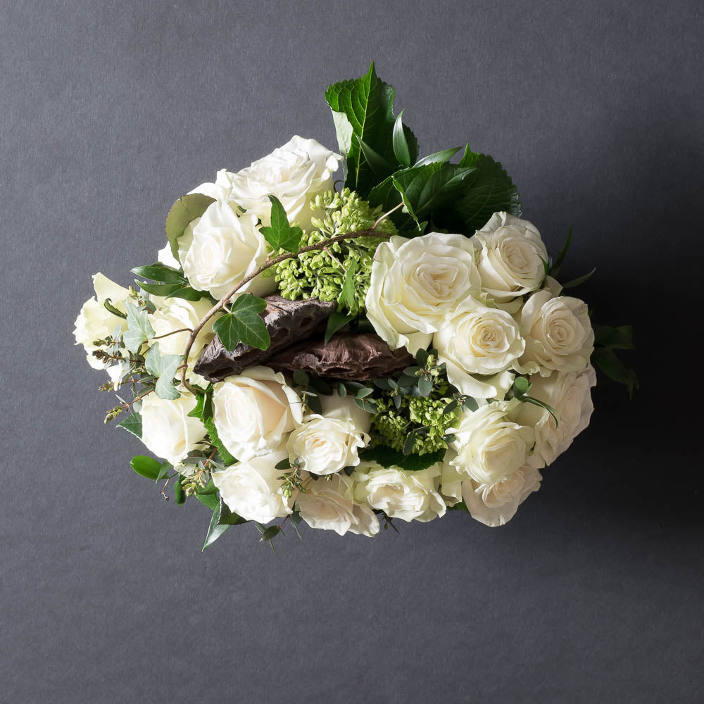 Unique boutique white flowers arrangement with all white roses