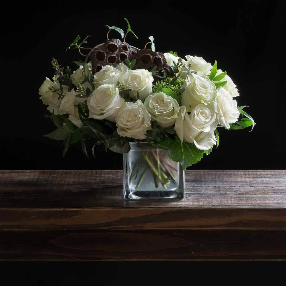 Unique boutique white flowers arrangement with all white roses