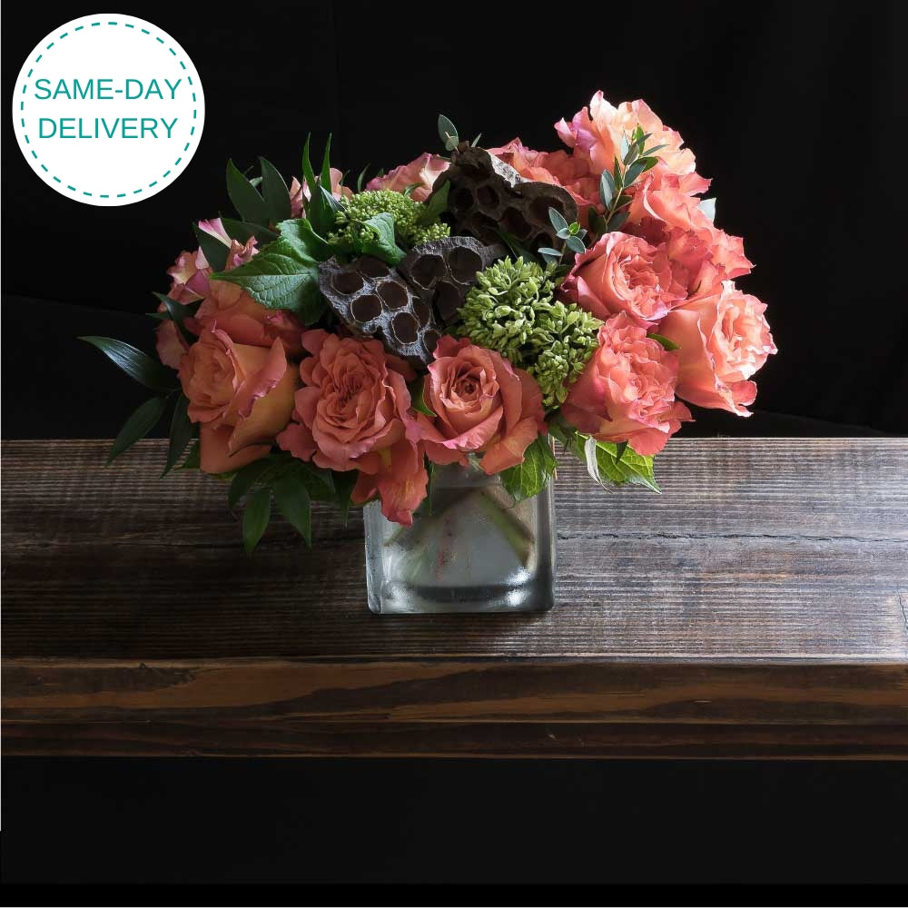 Boutique floral arrangement made out of all orange roses from the top