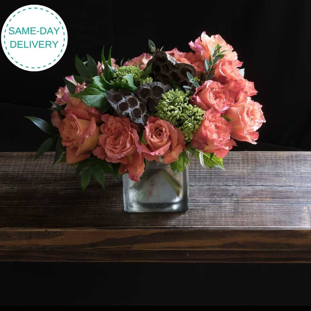 Boutique floral arrangement made out of all orange roses.