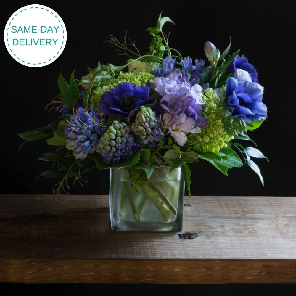 Cool unusual blue, indigo, purple floral arrangement of hydrangeas, blue hyacinths, and blue anemones.