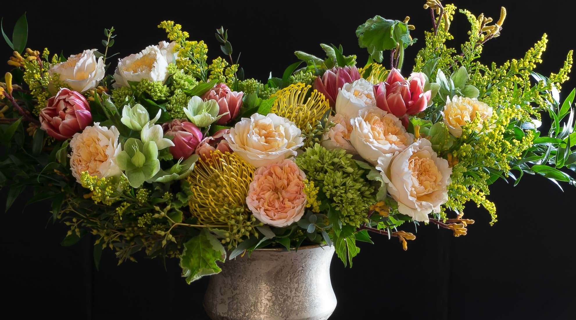 Colorful luxury boutique floral arrangement using the best premium flowers - blush, red, yellow, orange,  flowers