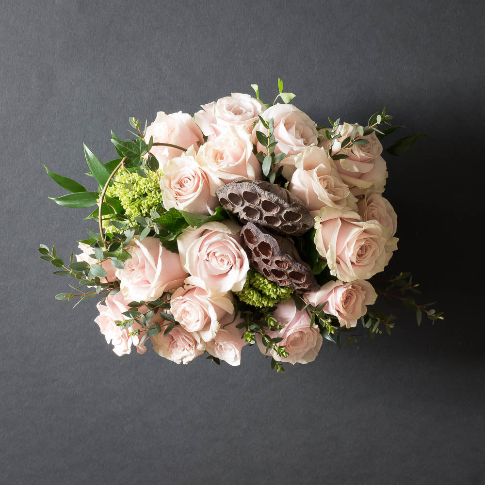 Boutique floral arrangement with all blush, light pink roses.