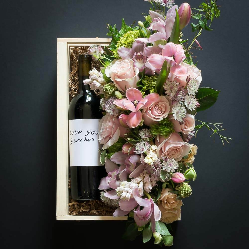Floral Basket Gift Box with boutique floral arrangement of soft pink roses, tulips and organic red sangiovese wine bottle