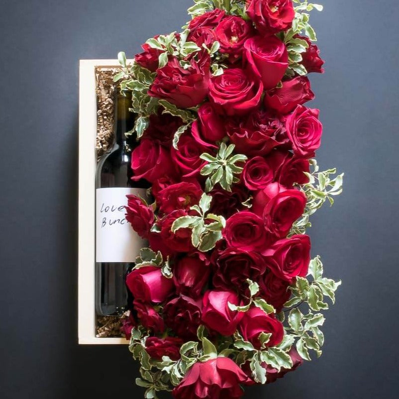 Floral Basket Gift Box with boutique floral arrangement red roses, tulips and organic red sangiovese wine bottle