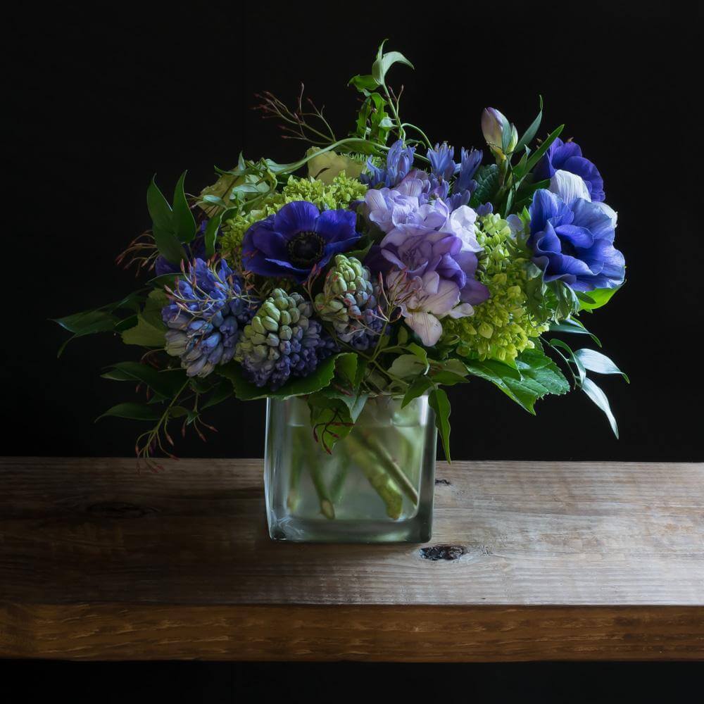 Cool unusual blue, indigo, purple floral arrangement of hydrangeas, blue hyacinths, and blue anemones.