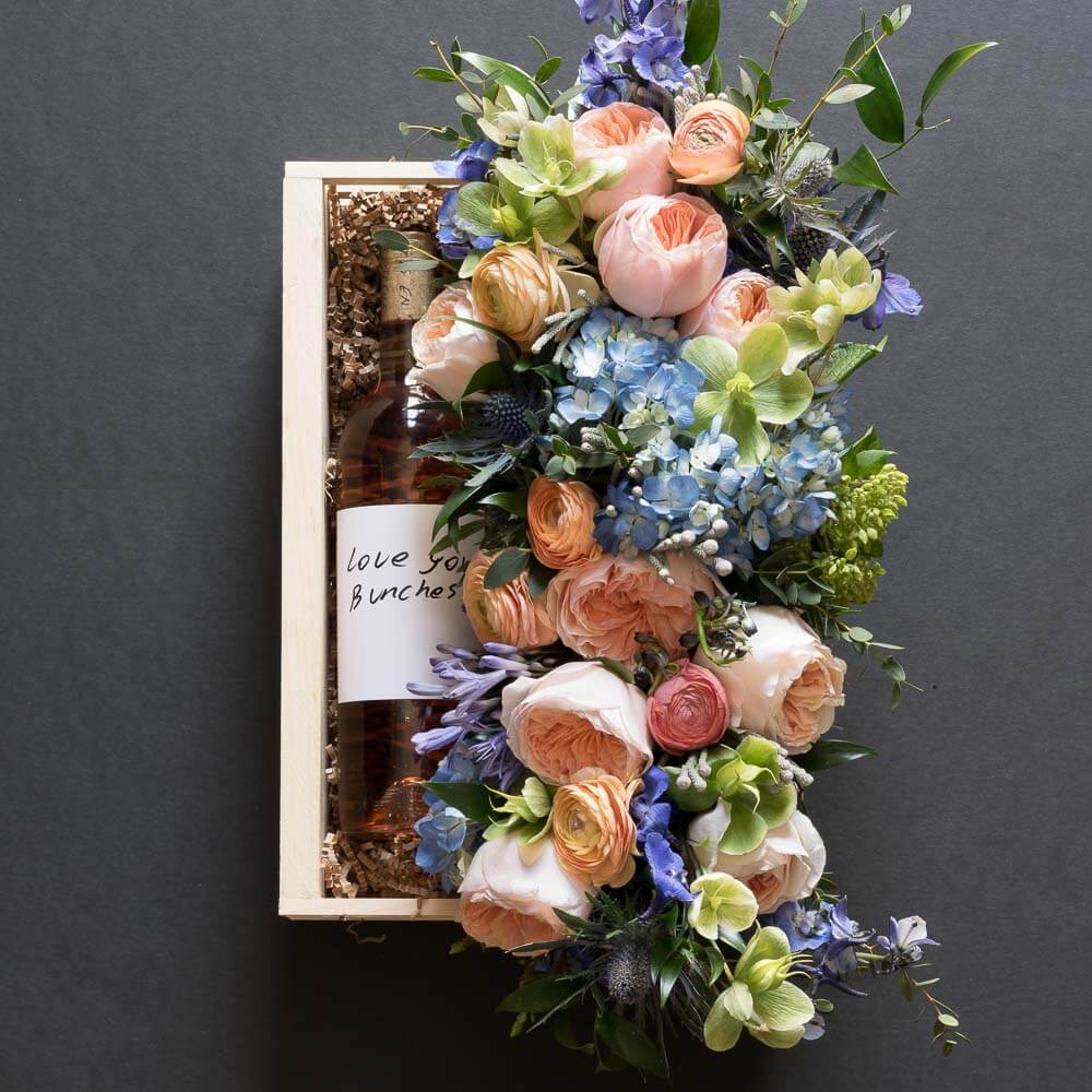 Jardin floral gift box with blush roses, blue flowers, hellebores, hydrangeas, with organic rose wine