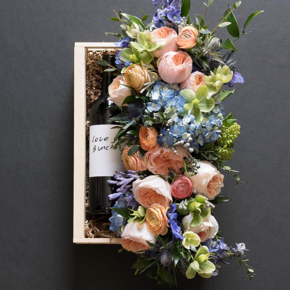 Jardin floral gift box with blush roses, blue flowers, hellebores, hydrangeas, with organic red wine