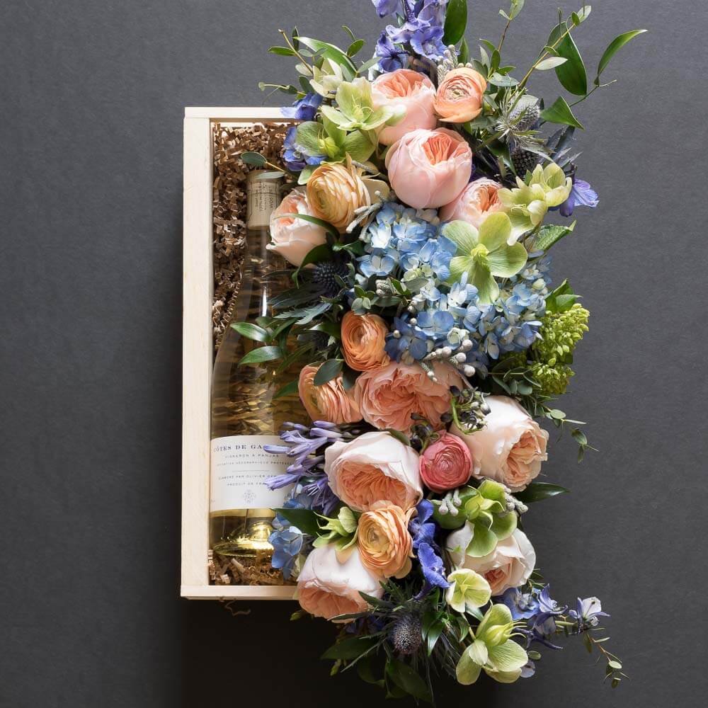 Jardin floral gift box with blush roses, blue flowers, hellebores, hydrangeas, with organic white wine