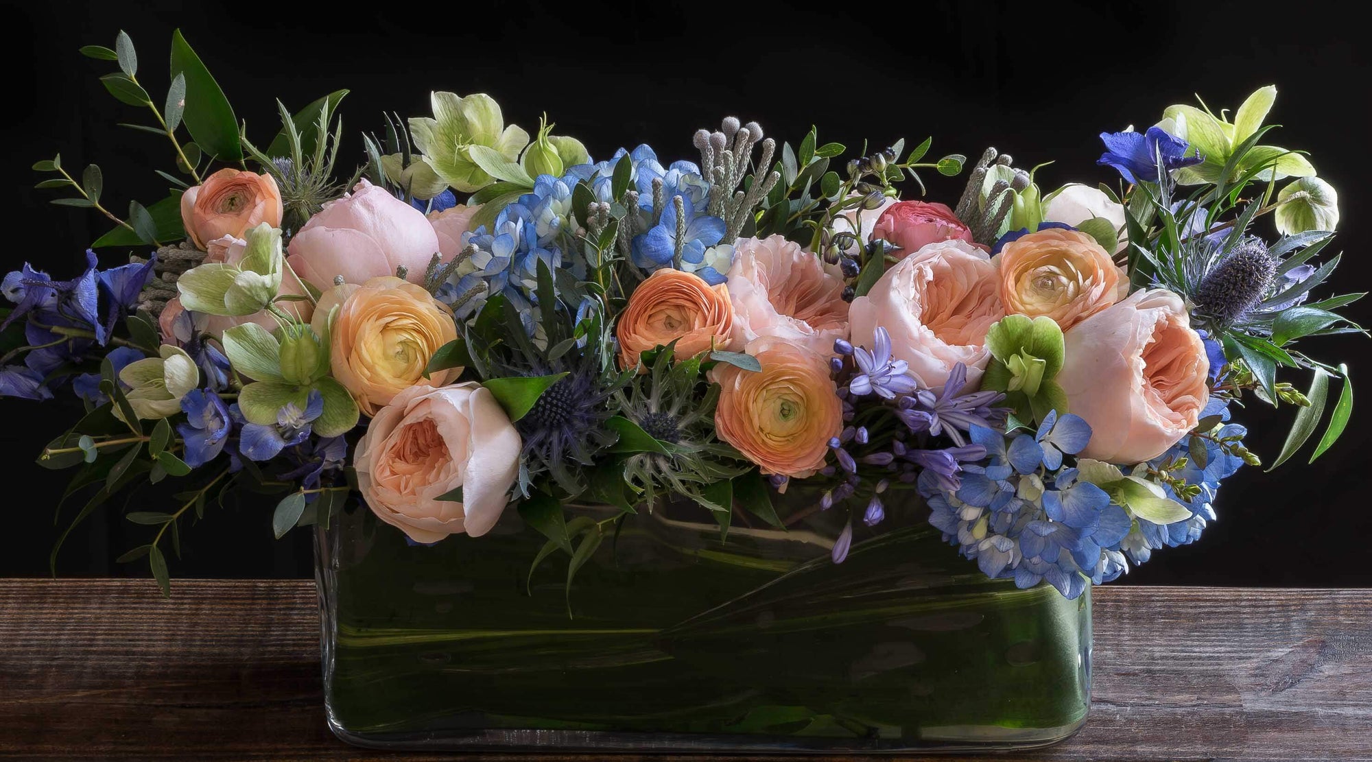 Colorful luxury boutique floral arrangement using the best premium flowers - blush, blue, orange,  flowers