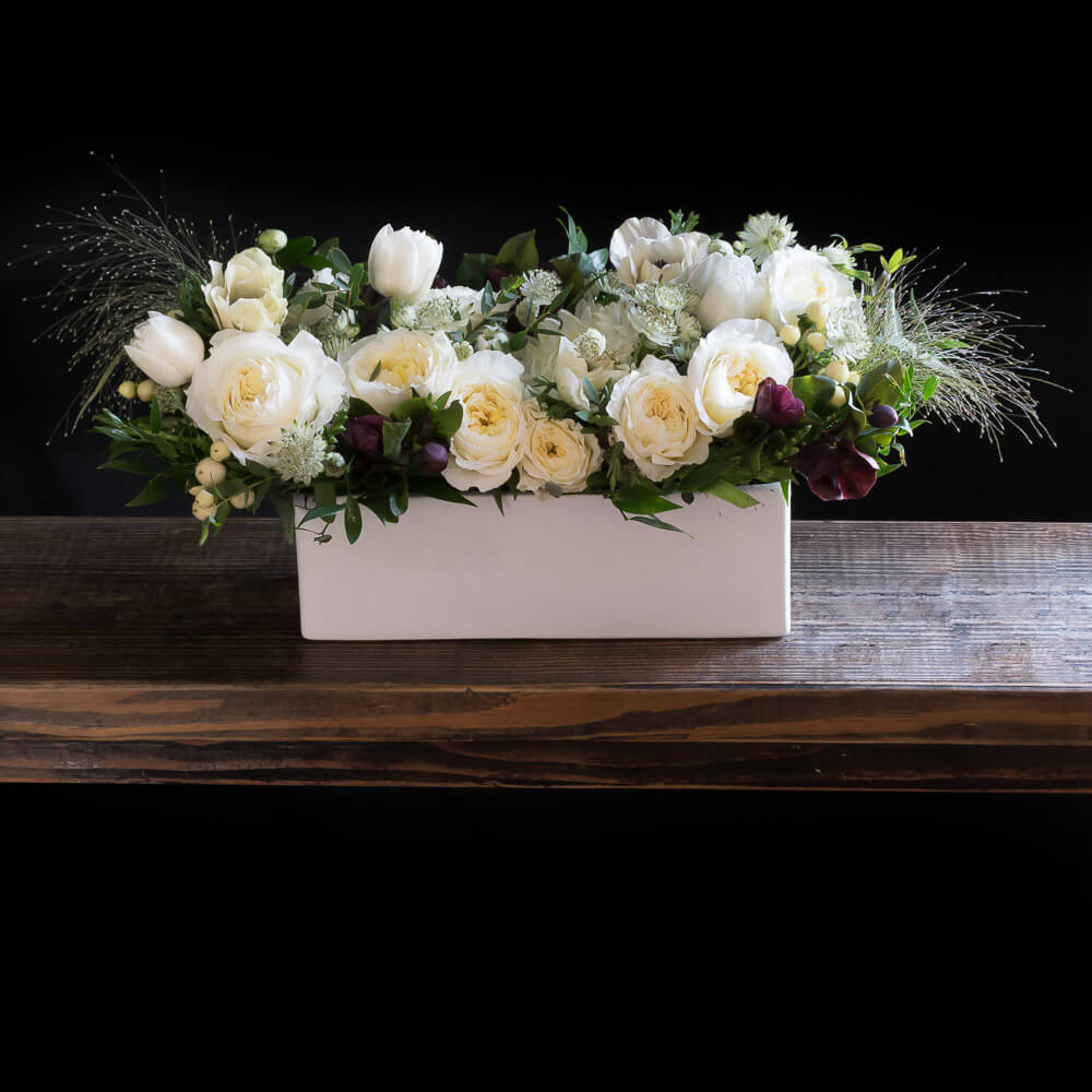 Holidays, Christmas centerpiece floral arrangement with white roses, white anemones, burgundy hellebores.