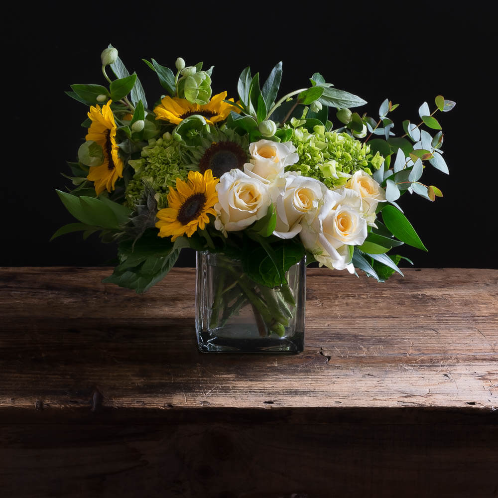 Sunflowers, white roses, mini green hydrangeas flower arrangement.