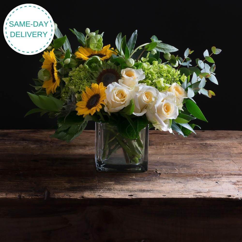 Sunflowers, white roses, mini green hydrangeas flower arrangement.