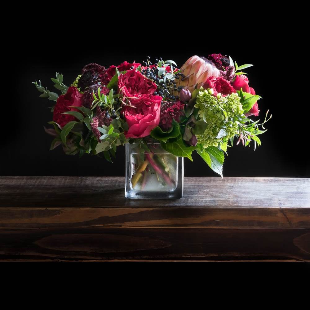 Valentines floral arrangement of red roses, light pink proteas.