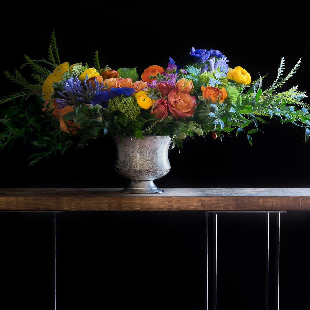 Beautiful flower arrangement with orange tulips, yellow flowers, pink roses and purple flowers