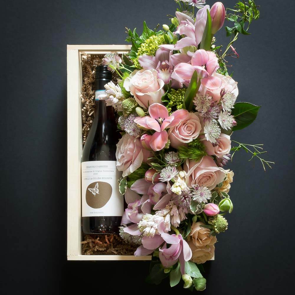 Floral Basket Gift Box with boutique floral arrangement of soft pink roses, tulips and organic red sangiovese wine bottle