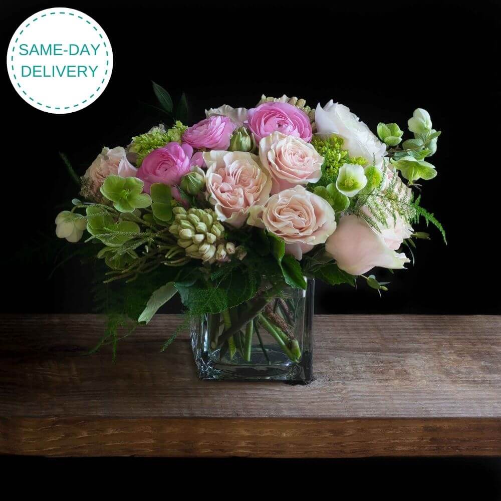 Beautiful unique boutique floral arrangement with light pink roses, fragrant garden roses, light pink ranunculus, and hyacinths.
