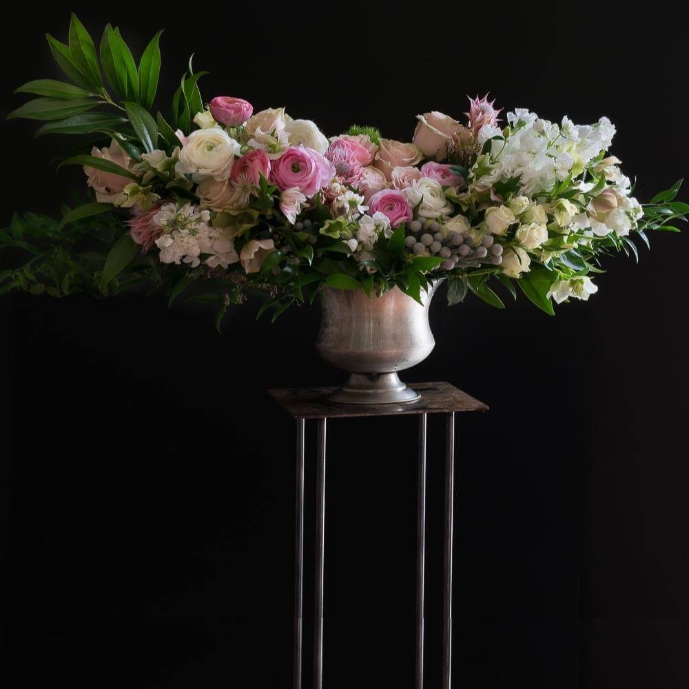 Luxe unique boutique floral arrangement with light pink roses, light pink ranunculus, and hyacinths.