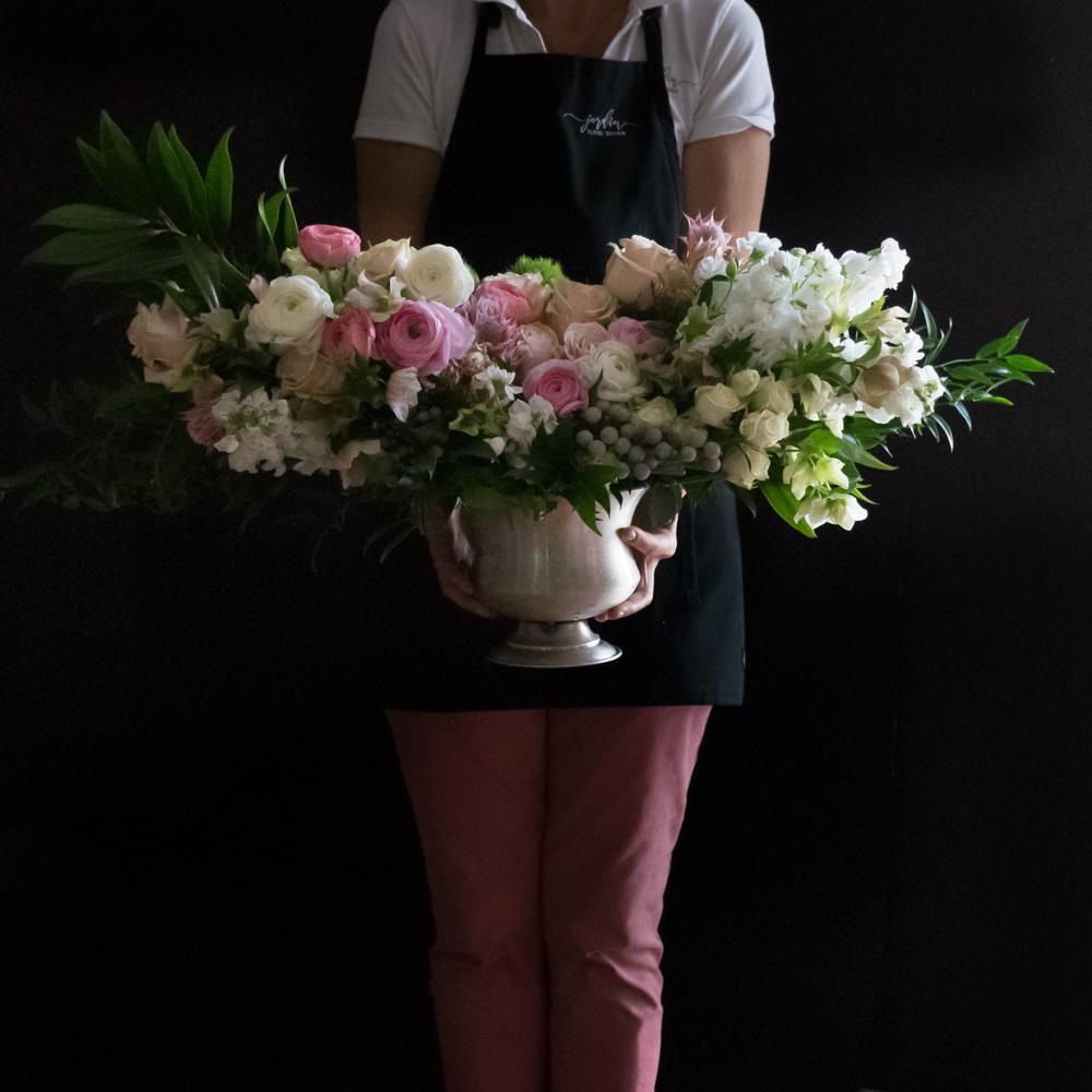 Luxe unique boutique floral arrangement with light pink roses, light pink ranunculus, and hyacinths.