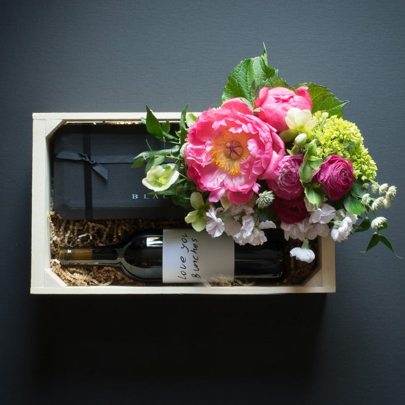 Boutique floral gift box with flowers, peonies, Norman Love ultra-premium 15 pc Black Box chocolate and organic sangiovese red wine.