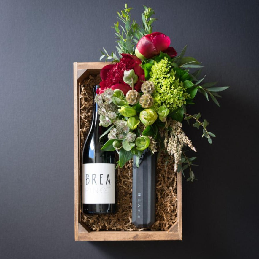 Boutique gift box with flowers, peonies, Norman Love chocolate and organic pinot red wine.