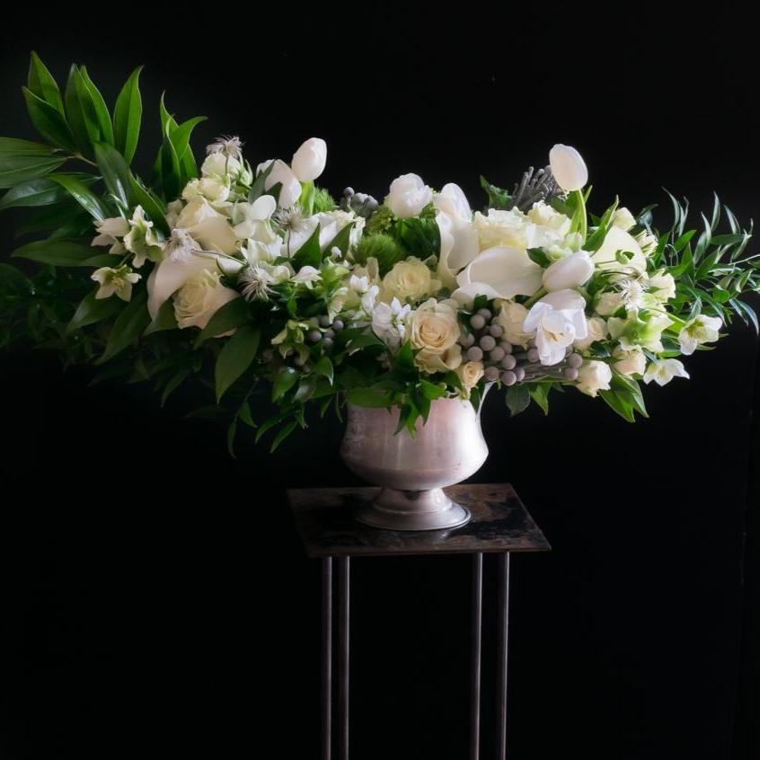 Large luxe boutique white flowers arrangement with white roses, white calla lilies, and white tulips