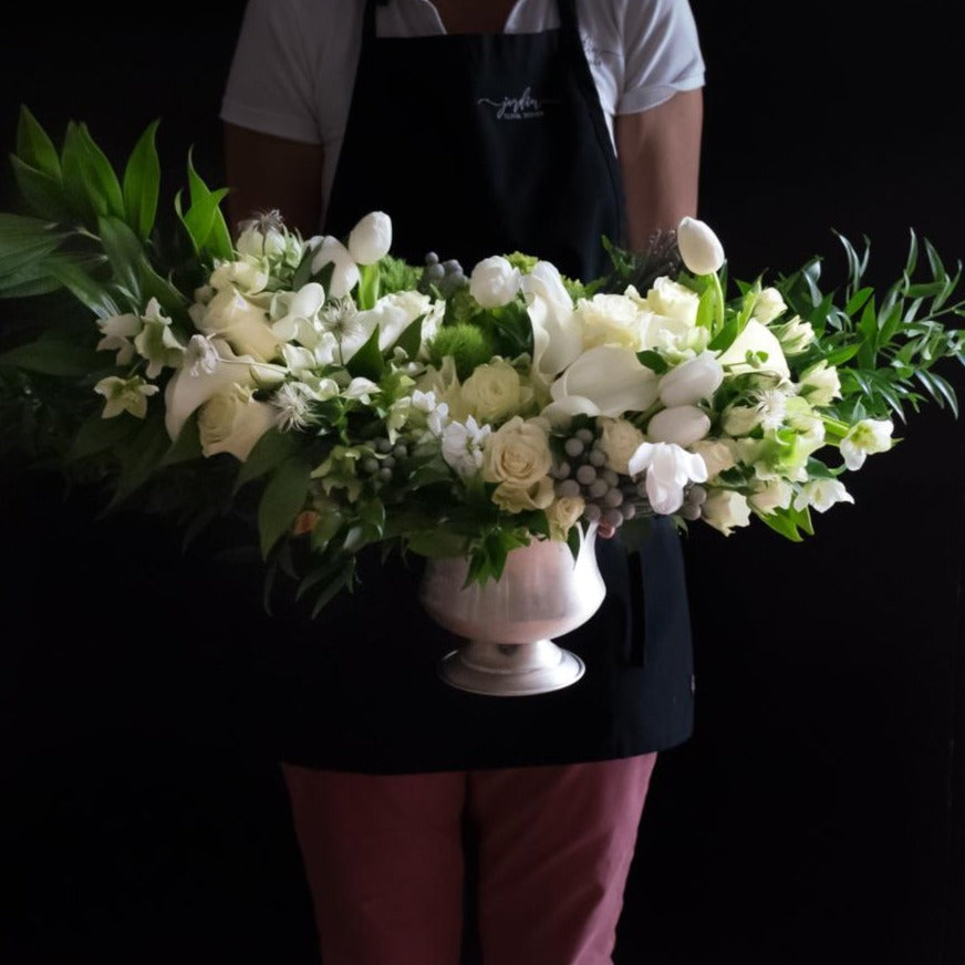Large luxe boutique white flowers arrangement with white roses, white calla lilies, and white tulips