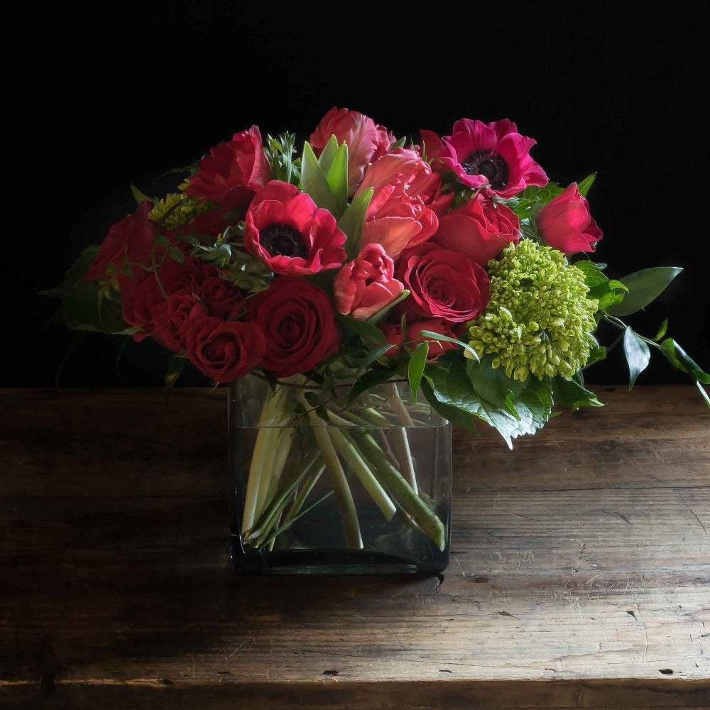 Red roses, red tulips, and red anemones floral arrangement